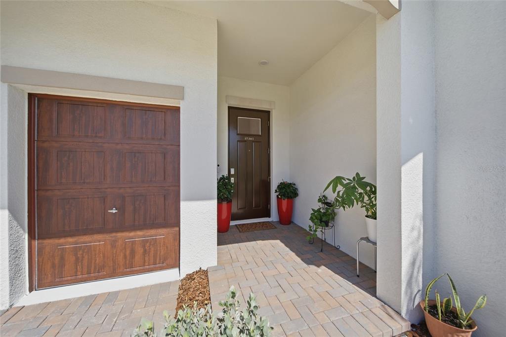 17301 Scuba Crest Street Wimauma, FL 33598 - Photo 2 of 37 a hallway with sliding door and wooden floor