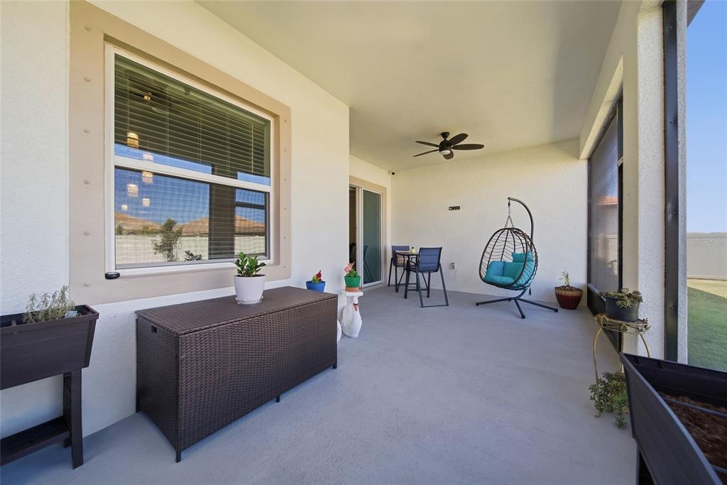 17301 Scuba Crest Street Wimauma, FL 33598 - Photo 22 of 37 a living room with furniture a window and a chandelier