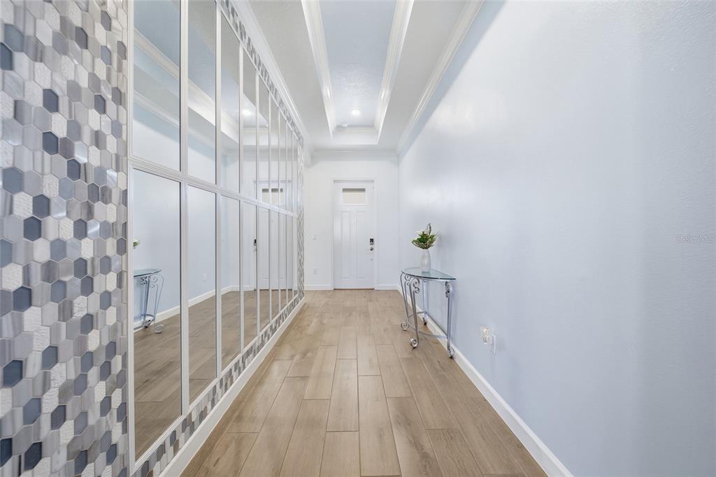 17301 Scuba Crest Street Wimauma, FL 33598 - Photo 9 of 37 a view of a hallway with wooden floor and staircase
