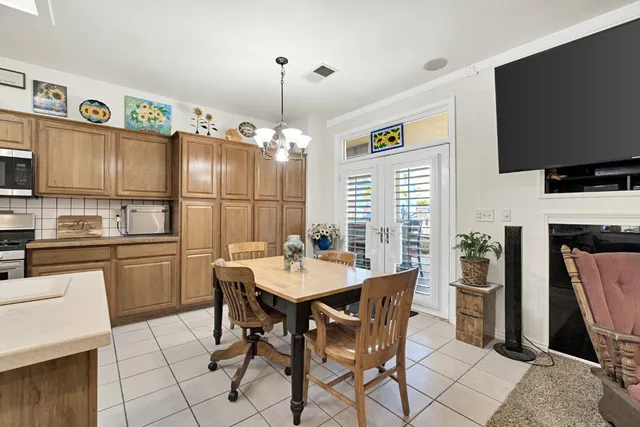 a kitchen with refrigerator and table