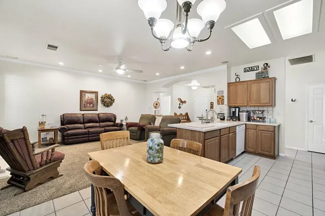 a large kitchen with a table and chairs