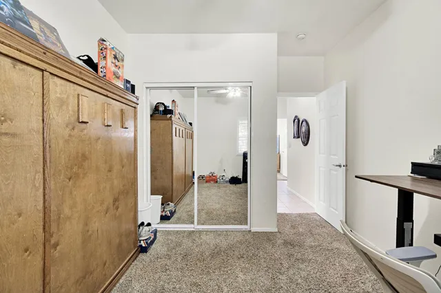a view of a hallway with wooden shelves