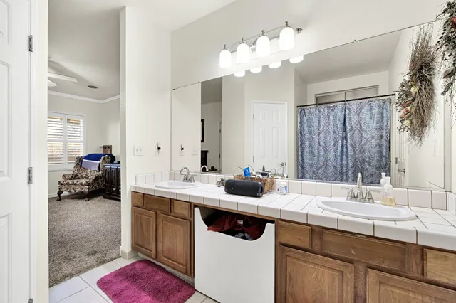 a bathroom with a sink double vanity granite and a mirror
