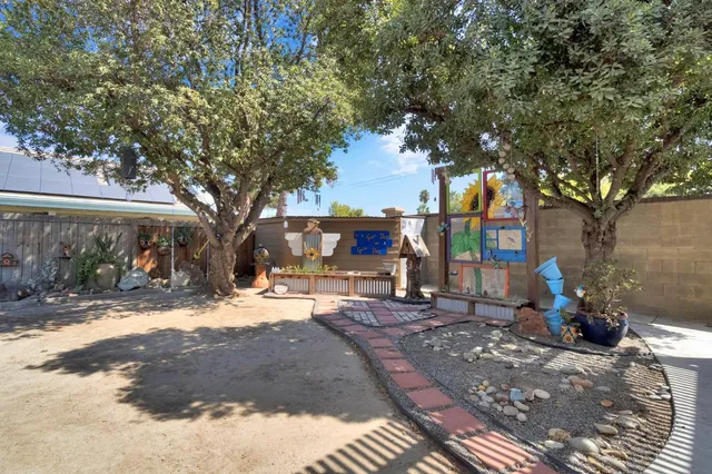 a view of a house with a tree in the background
