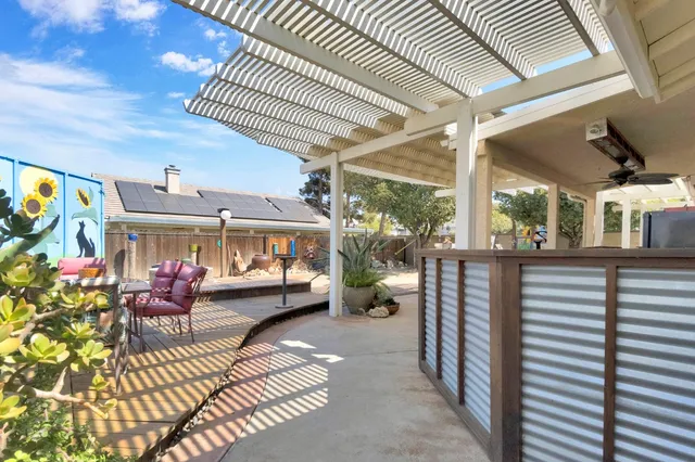 a bedroom with furniture and a large window