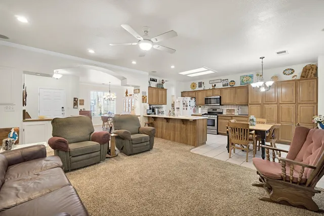 a living room with lots of furniture and kitchen view