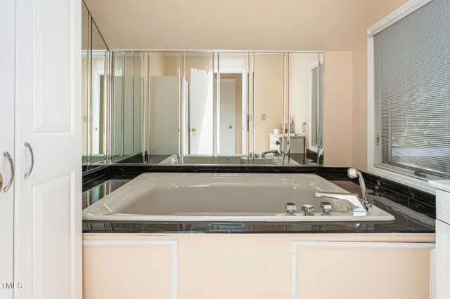 a view of a sink a bath tub and a window