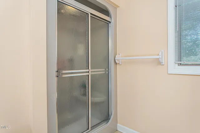 a bathroom with a glass shower door