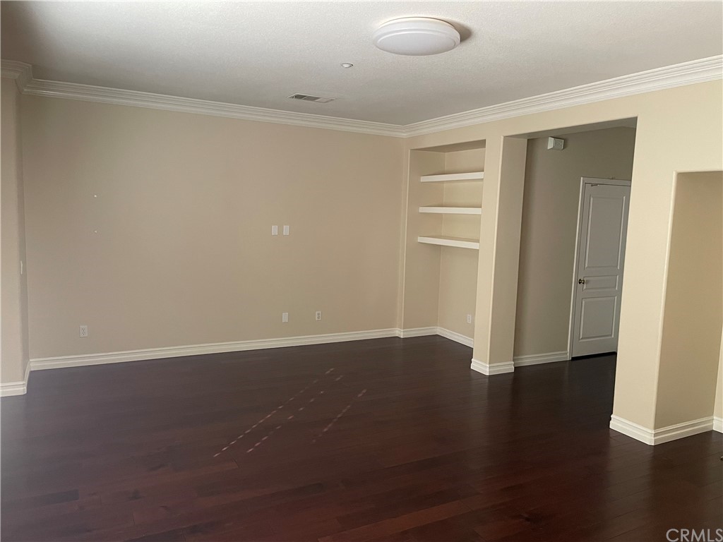 202 Wild Lilac Irvine, CA 92620 - Photo 3 of 10 a view of an empty room with wooden floor and closet
