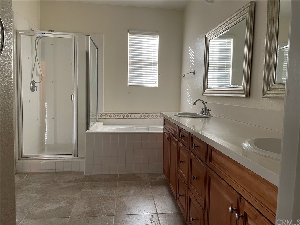202 Wild Lilac Irvine, CA 92620 - Photo 7 of 10 a spacious bathroom with a sink mirror vanity and a bathtub