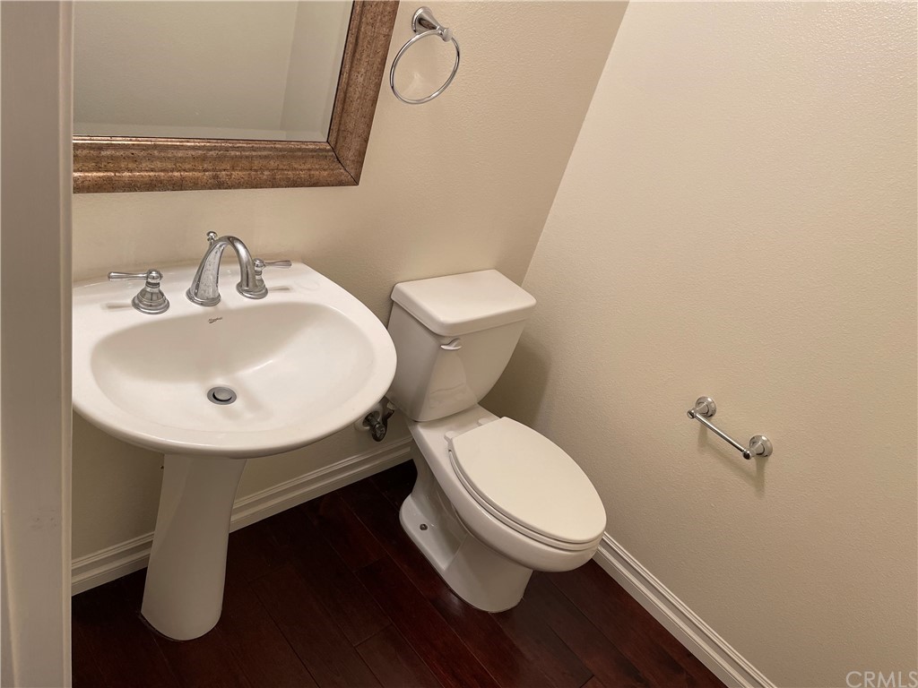 202 Wild Lilac Irvine, CA 92620 - Photo 9 of 10 a white toilet sitting next to a bathroom sink