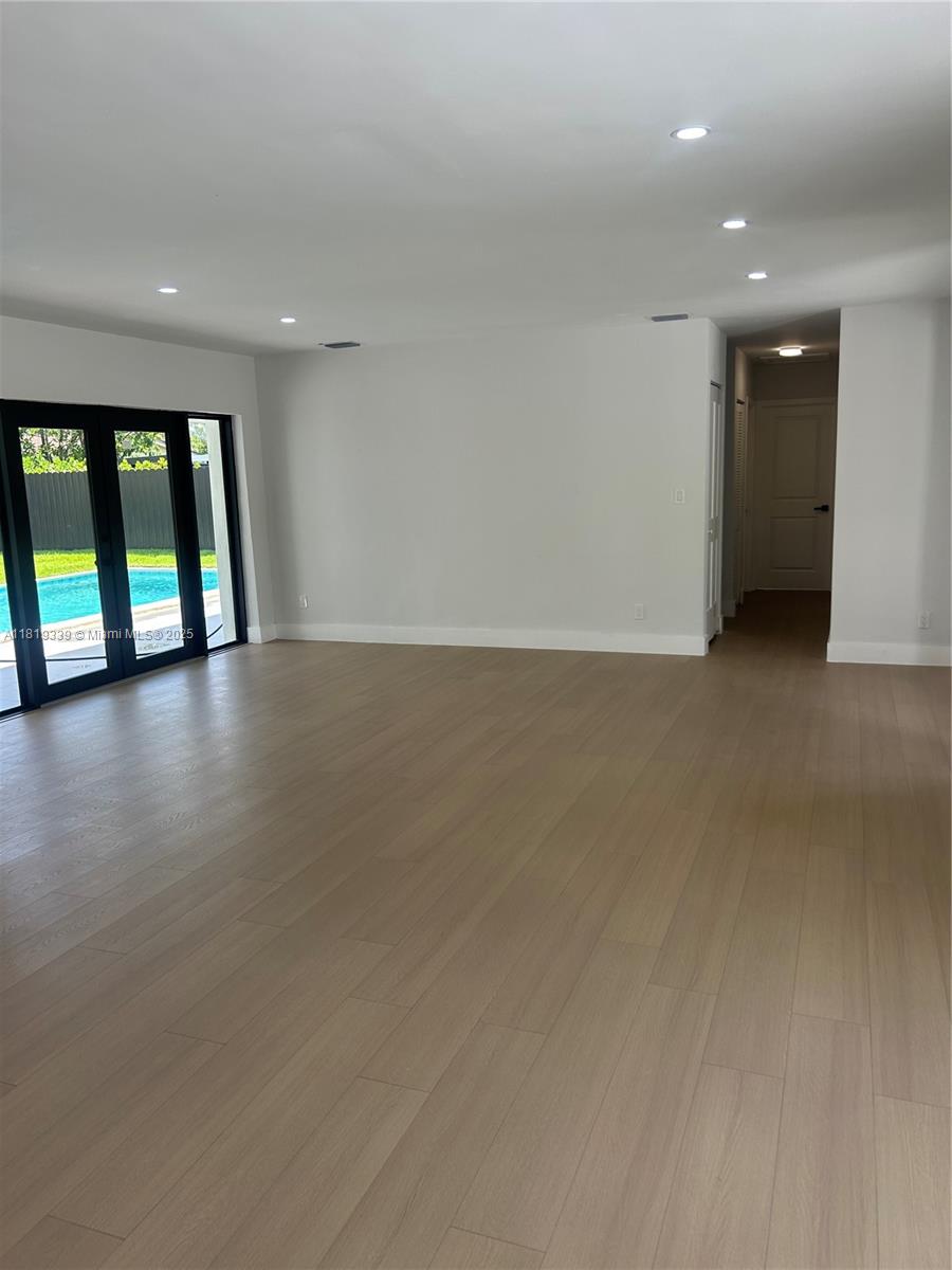 Westchester Miami, FL 33165 - Photo 14 of 25 an empty room with wooden floor and windows