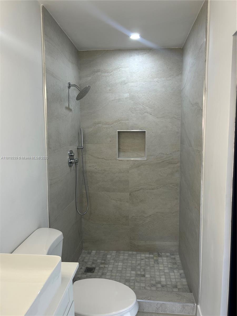 Westchester Miami, FL 33165 - Photo 17 of 25 a bathroom with a toilet and a shower
