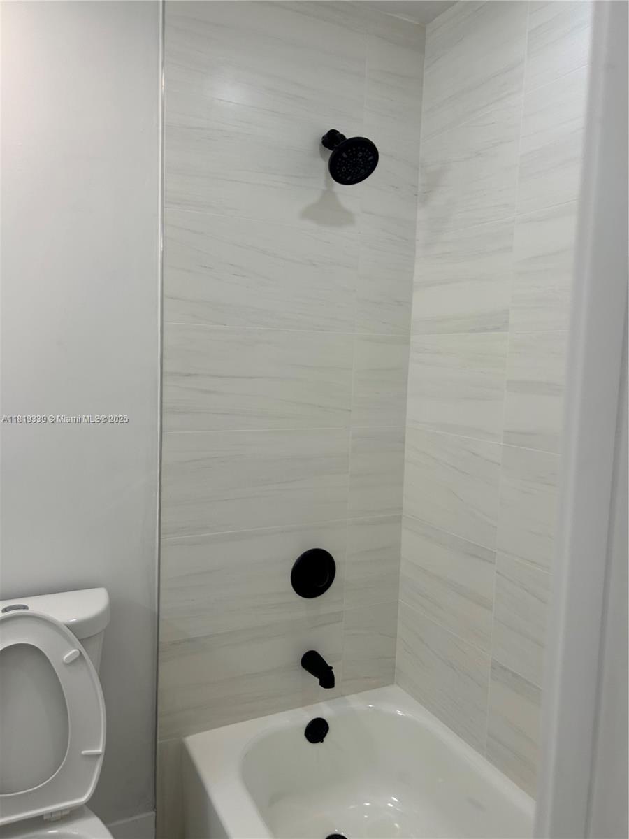 Westchester Miami, FL 33165 - Photo 18 of 25 a bathroom with a sink toilet a mirror and shower