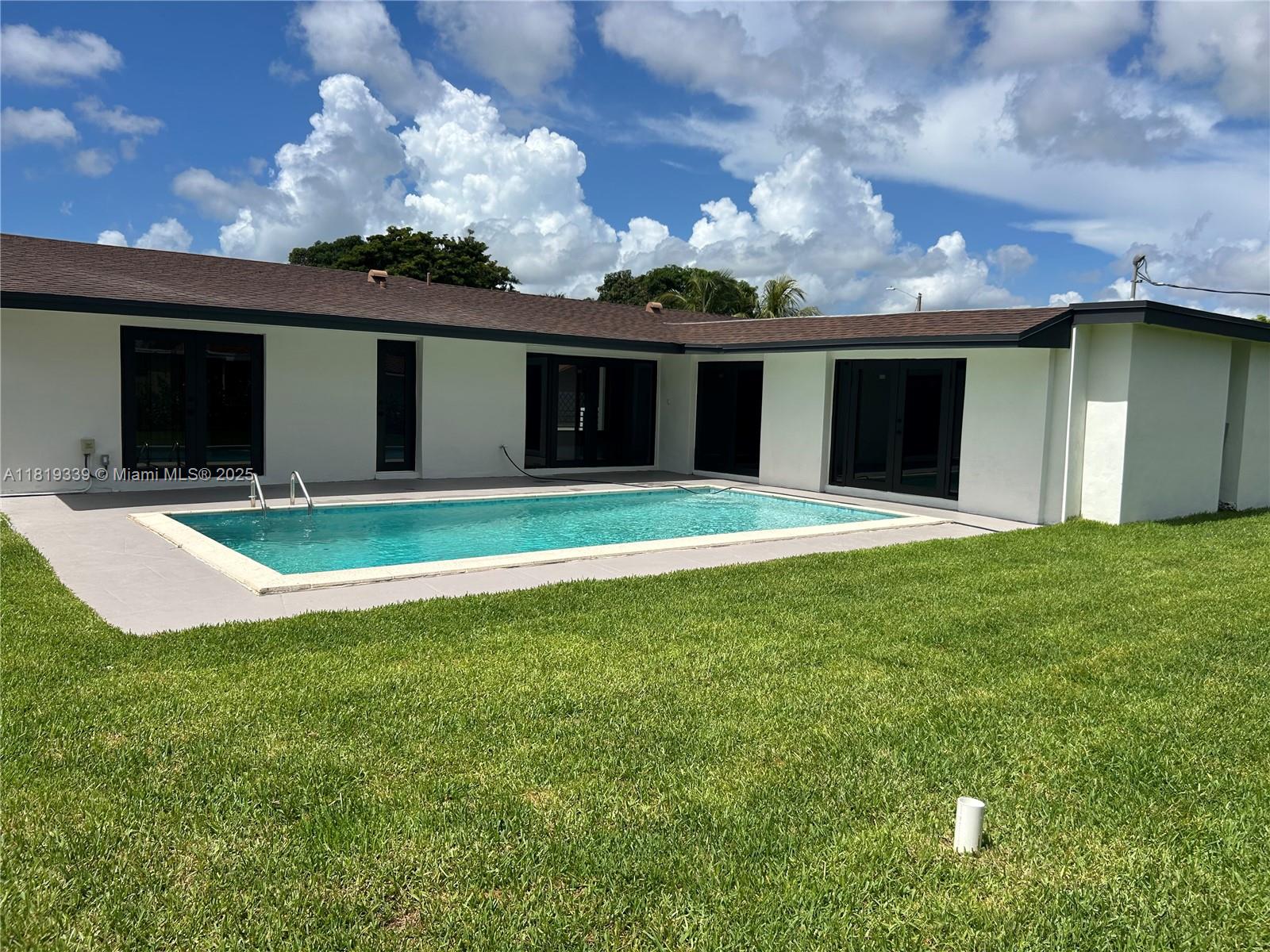 Westchester Miami, FL 33165 - Photo 23 of 25 a view of a house with a yard and garage