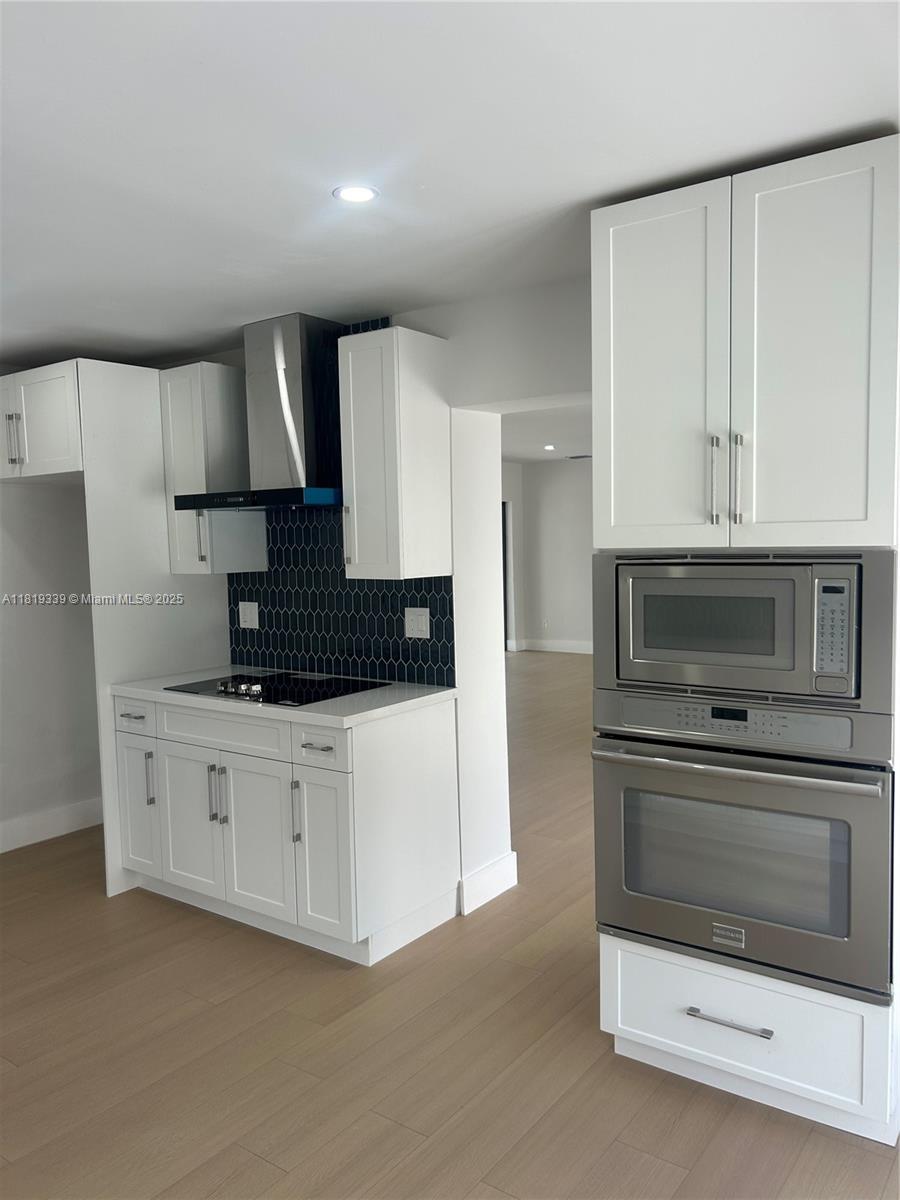 Westchester Miami, FL 33165 - Photo 4 of 25 a kitchen with granite countertop white cabinets white stainless steel appliances and a refrigerator