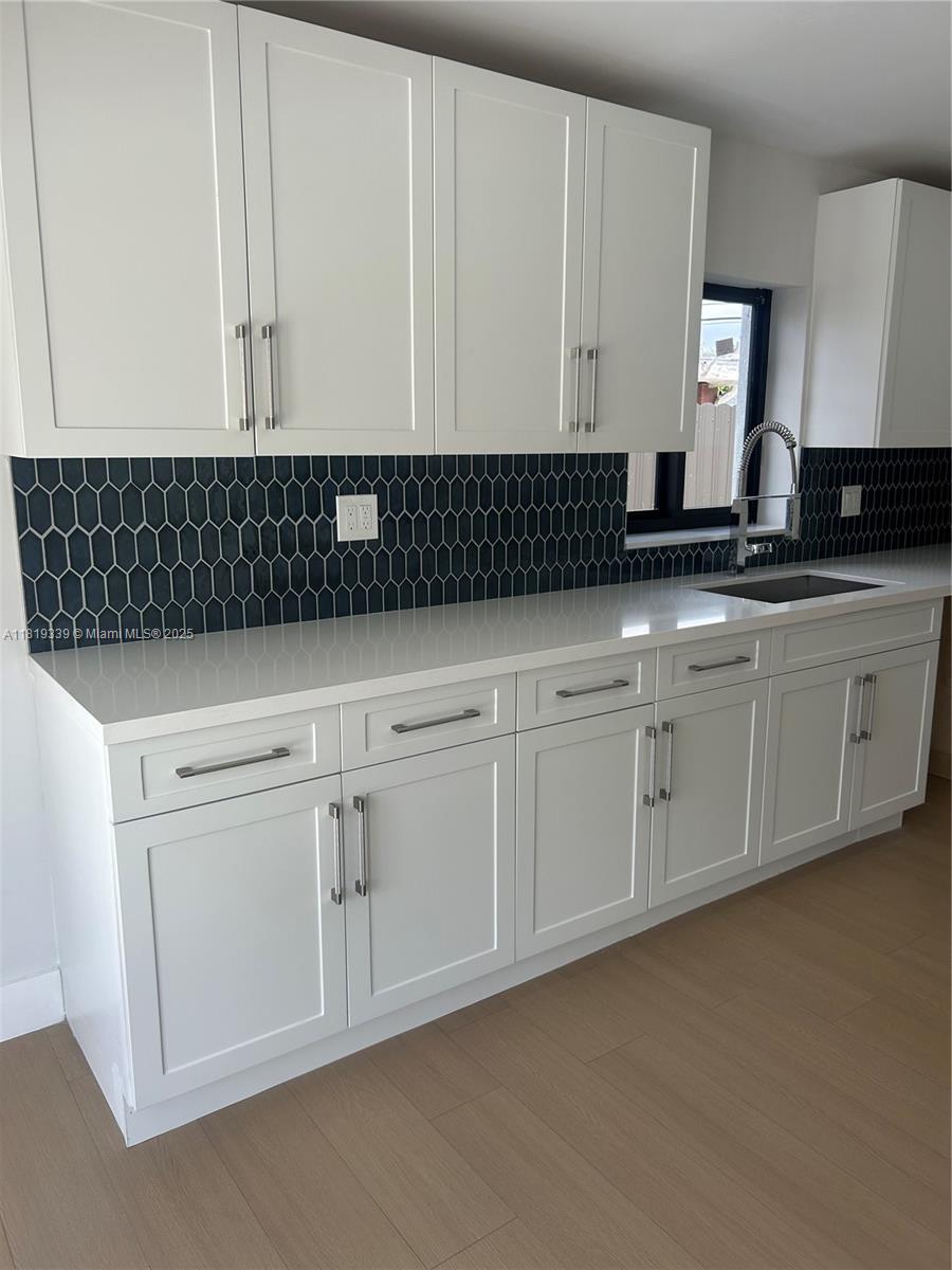 Westchester Miami, FL 33165 - Photo 5 of 25 a kitchen with white cabinets