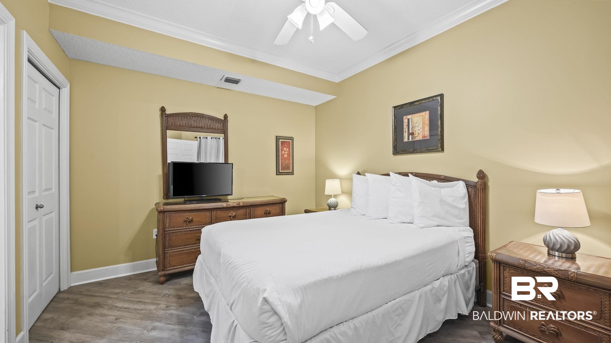 27580 Canal Road, Unit 214 BS 62 Orange Beach, AL 36561 - Photo 12 of 23 Bedroom featuring crown molding, dark wood-style floors, a ceiling fan, and a closet
