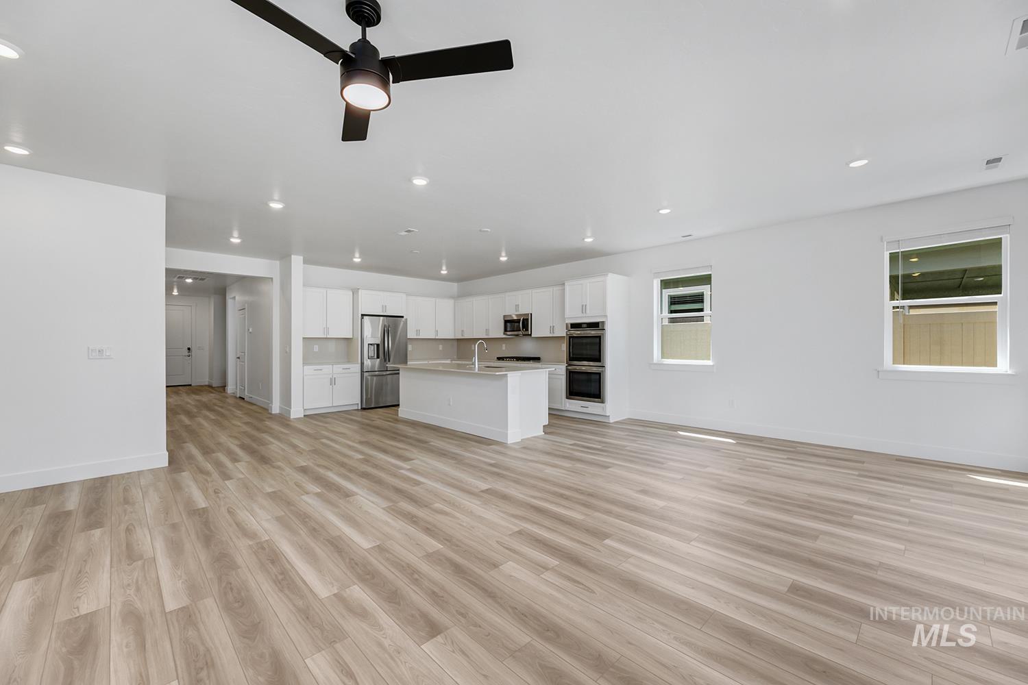 4548 West Wapoot Street Meridian, ID 83646 - Photo 4 of 17 Spacious open-concept living area featuring wood-finish flooring and a contemporary kitchen
