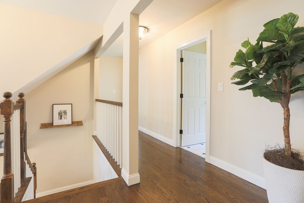 6 Kate's Lane Boxford, MA 01921 - Photo 23 of 36 a view of a hallway with wooden floor and staircase
