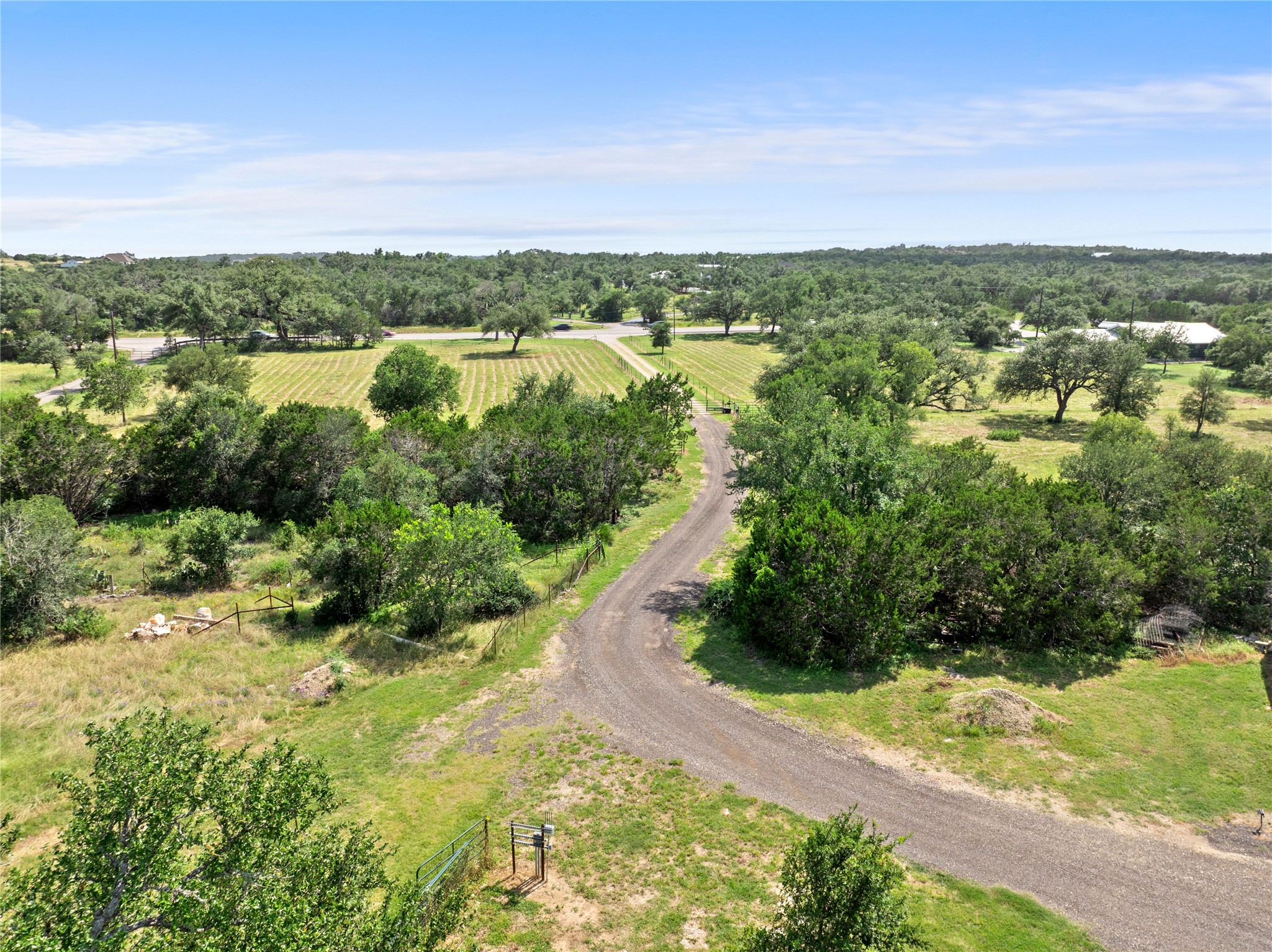 8200 Ranch Road 12 San Marcos, TX 78666 - Photo 6 of 40 A winding gravel path guides you through a serene, tree-dotted landscape, offering privacy and natural beauty.