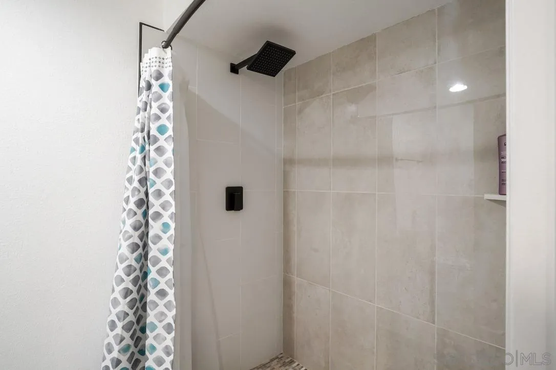 13053 Caminito Del Rocio Del Mar, CA 92014 - Photo 25 of 49 a bathroom with a shower curtain and a sink
