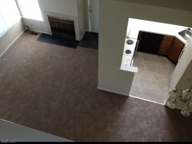 a view of living room with furniture and a fireplace