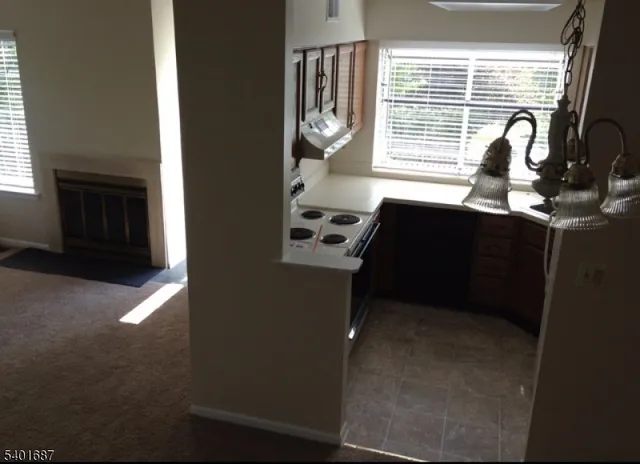 a kitchen with granite countertop a stove and a microwave