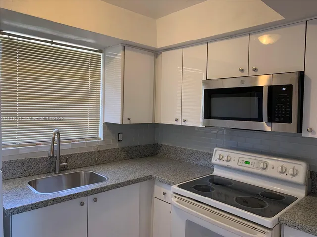 a kitchen with a stove and a microwave