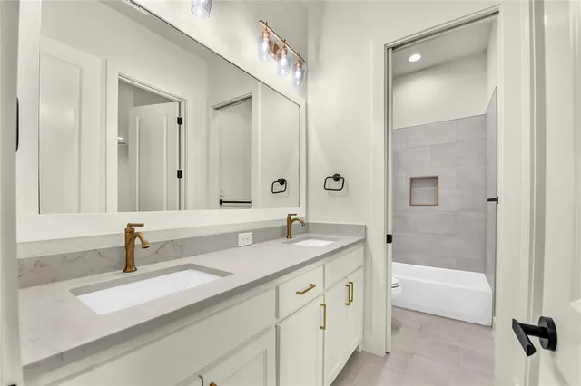 a bathroom with a tub sink and mirror