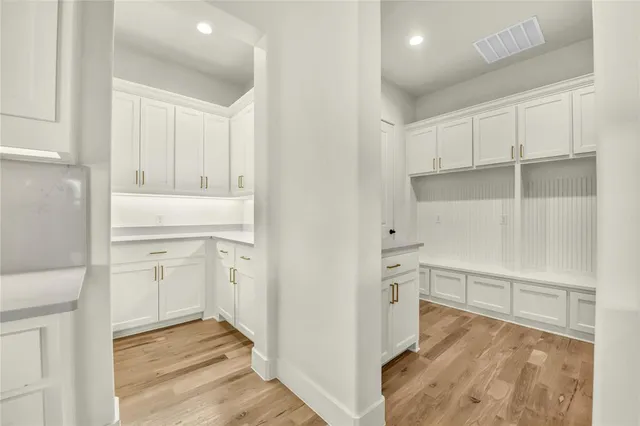 a view of cabinets and wooden floor