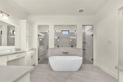 a spacious bathroom with a tub sink shower and mirror