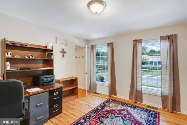 a view of room with window and wooden floor