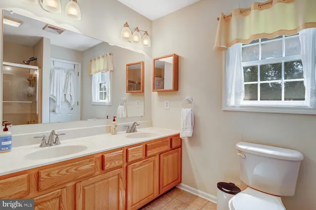 a bathroom with a granite countertop sink mirror and double