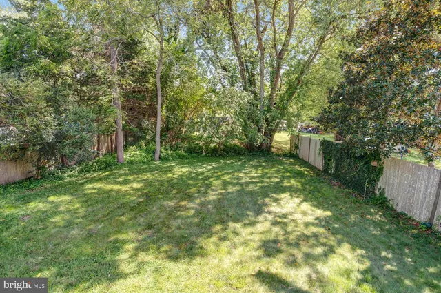 a backyard of a house with lots of green space and fountain