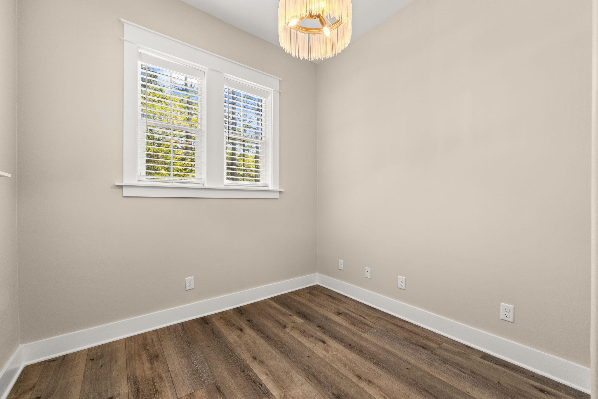 102 Churchill Drive Santa Rosa Beach, FL 32459 - Photo 49 of 89 an empty room with wooden floor and windows