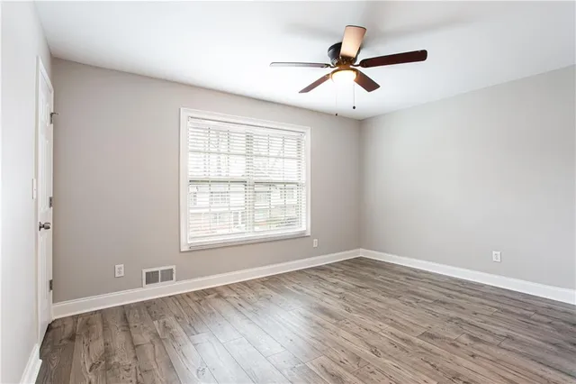 wooden floor in an empty room with a window