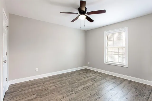 wooden floor in an empty room with a window