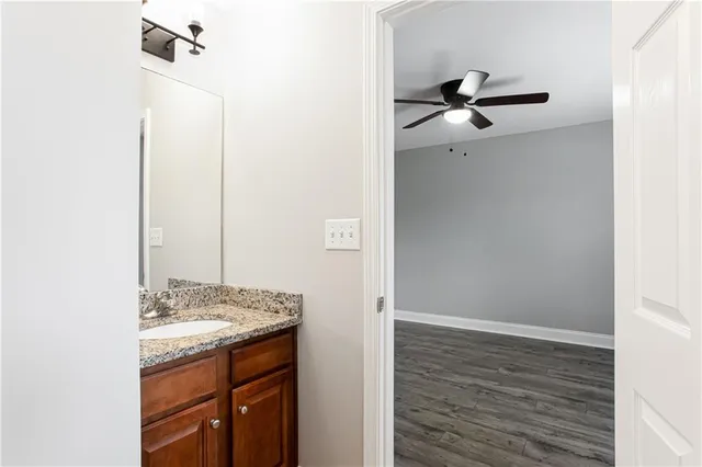 a bathroom with a granite countertop sink and a mirror