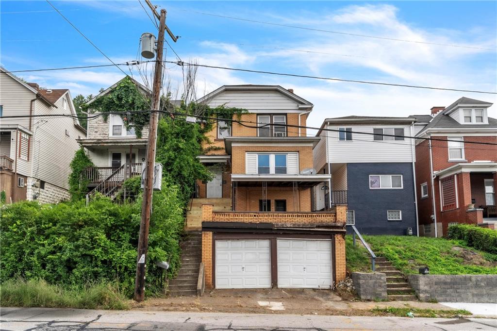 a front view of a building with garden