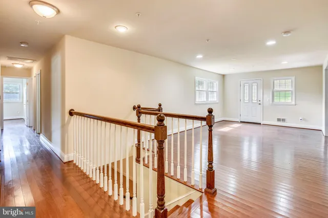 a view of a hallway with wooden floor