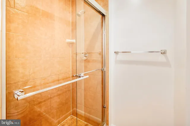 a bathroom with a granite countertop sink a toilet and a mirror