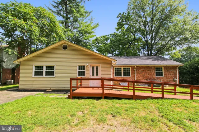 a view of a house with a yard and sitting area