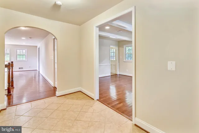 a view of a hallway view with wooden floor and staircase