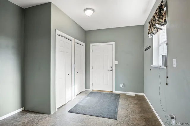 an empty room with windows and closet