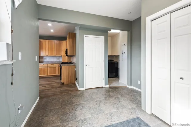 a view of a kitchen with a refrigerator and a sink