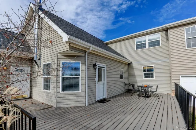 a view of backyard with a deck and wooden floor