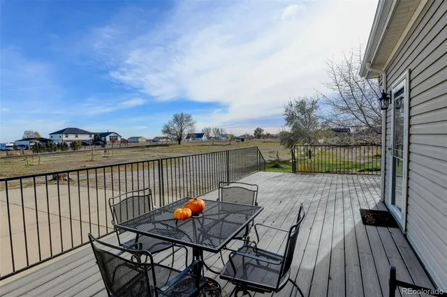 a view of a roof deck with wooden floor and city view