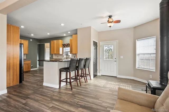 a living room with furniture and kitchen view