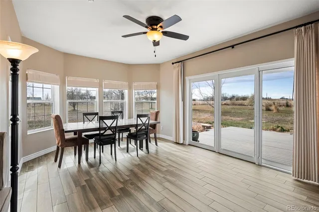 a dining room with furniture water view and wooden floor